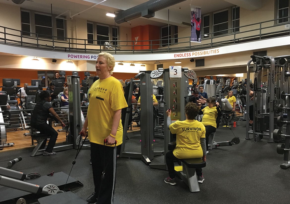 Women in yellow shirts working out at the Waterbury YMCA gym